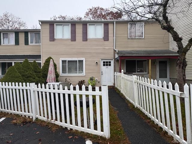 a view of a house with wooden fence