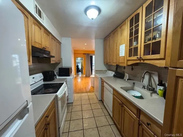 a kitchen with stainless steel appliances a sink stove and cabinets