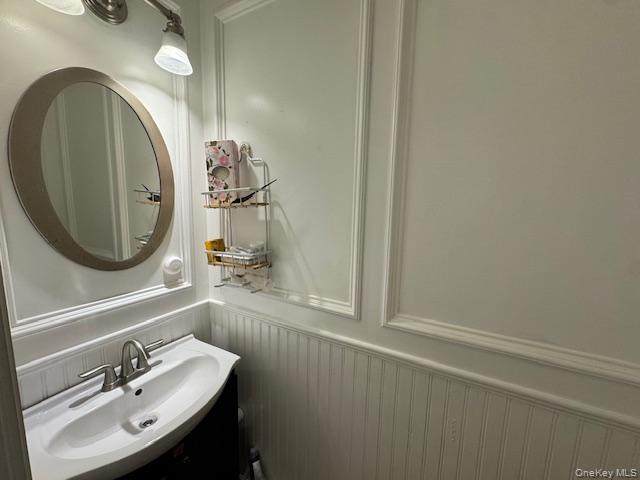 227 Hill Rise Calverton, NY 11933 - Photo 8 of 21 a bathroom with a sink and a mirror