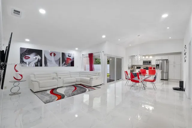 a living room with furniture and air hockey table