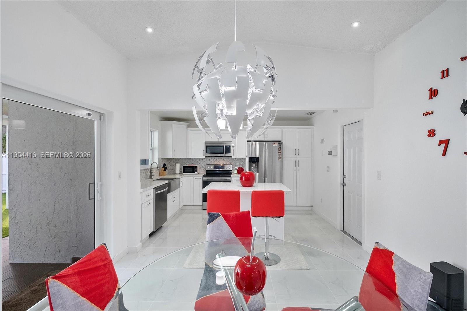 26161 Southwest 130th Avenue Homestead, FL 33032 - Photo 12 of 51 a very nice looking room with a dining table painted walls and white walls