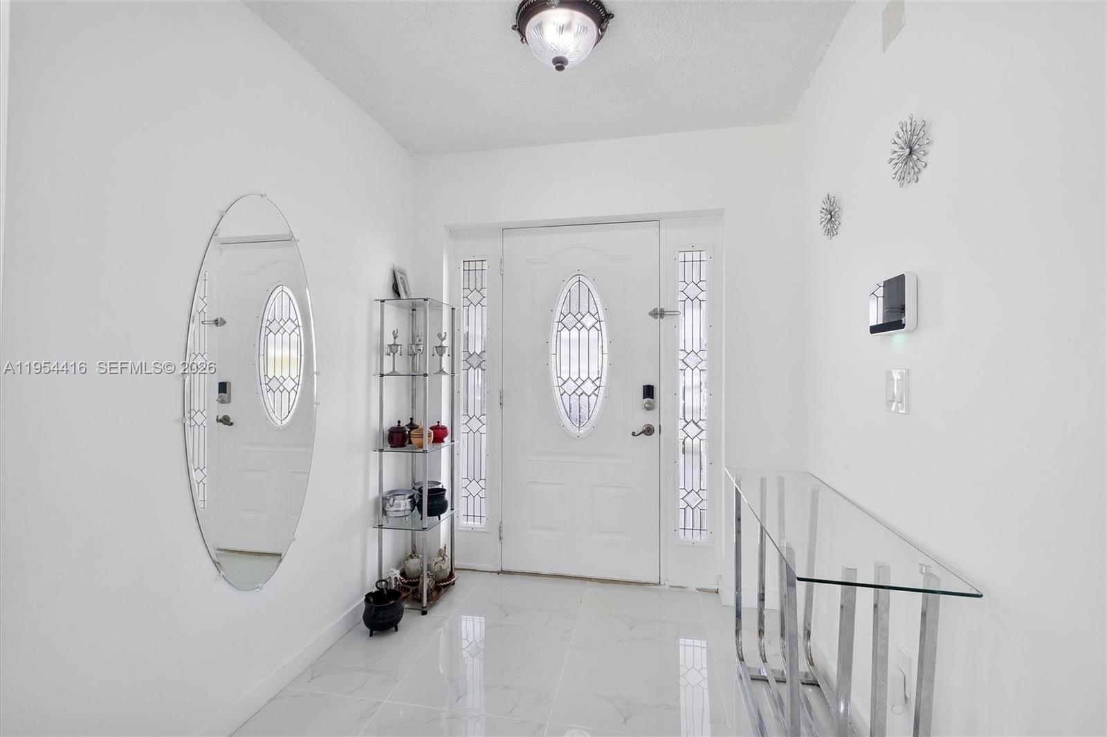 26161 Southwest 130th Avenue Homestead, FL 33032 - Photo 4 of 51 a view of a livingroom with wooden floor and a ceiling fan