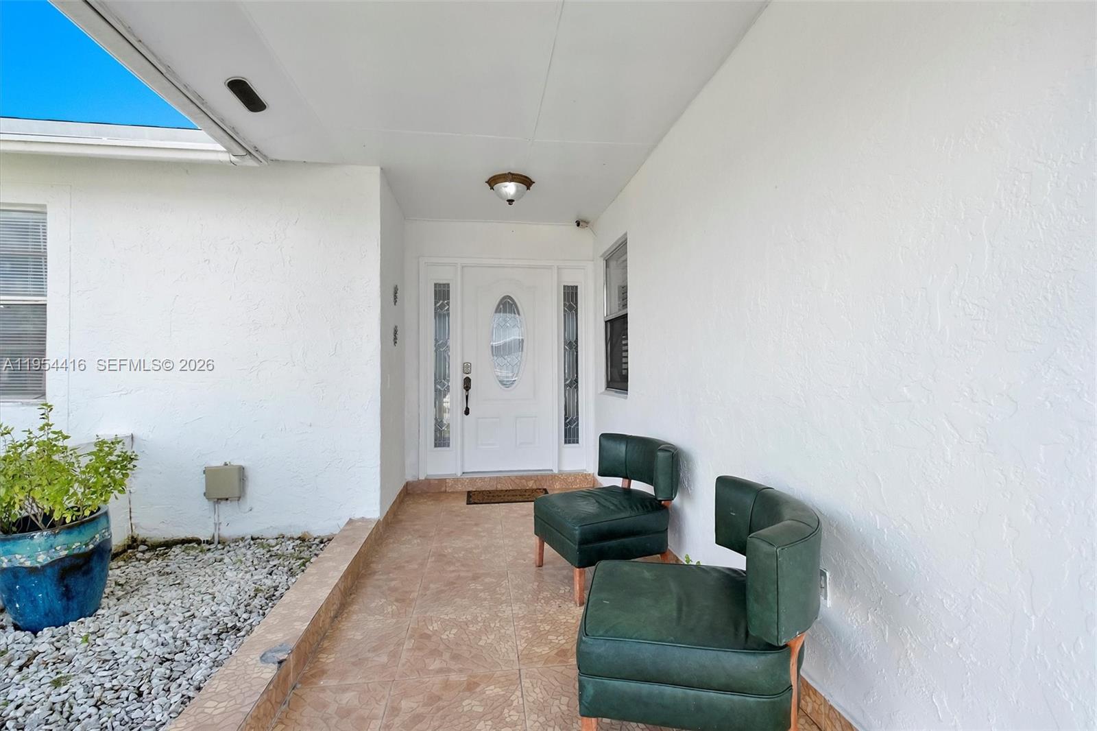 26161 Southwest 130th Avenue Homestead, FL 33032 - Photo 6 of 51 a living room with furniture and flowers