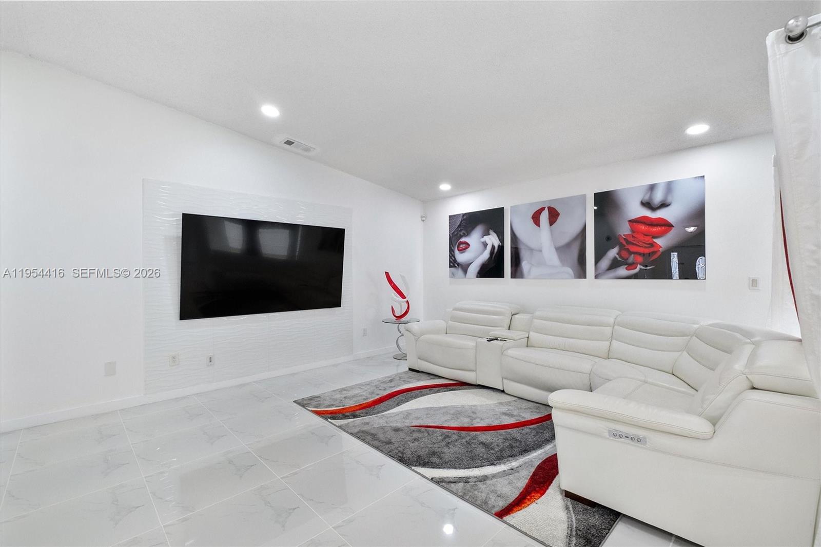 26161 Southwest 130th Avenue Homestead, FL 33032 - Photo 10 of 51 a living room with furniture and a flat screen tv