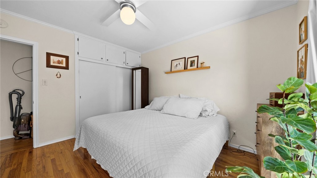 1406 17th Street Manhattan Beach, CA 90266 - Photo 17 of 60 a bedroom with a bed and a potted plant