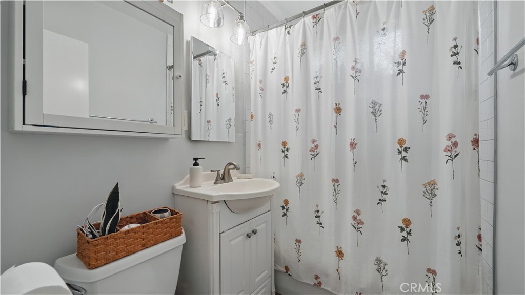 1406 17th Street Manhattan Beach, CA 90266 - Photo 42 of 60 a bathroom with a sink a toilet and shower curtain