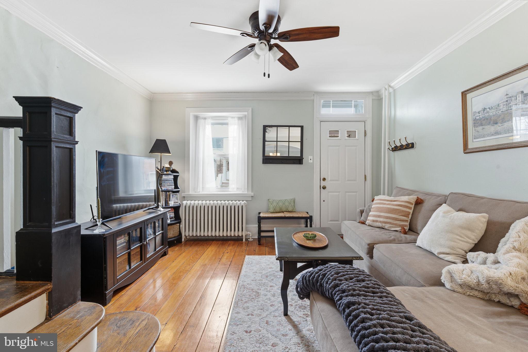 a living room with furniture a couch and a flat screen tv