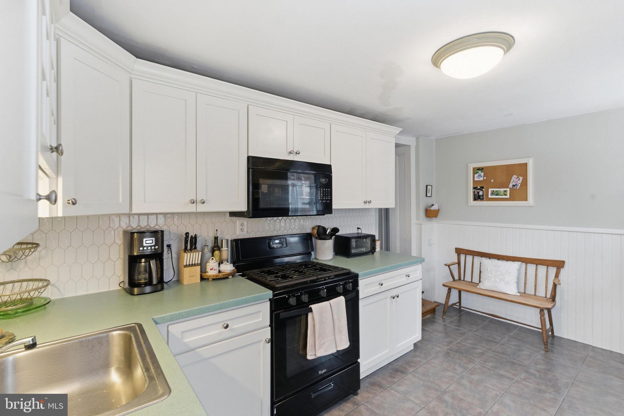 405 Leverington Avenue Philadelphia, PA 19128 - Photo 11 of 25 a kitchen with stainless steel appliances granite countertop a sink stove and cabinets