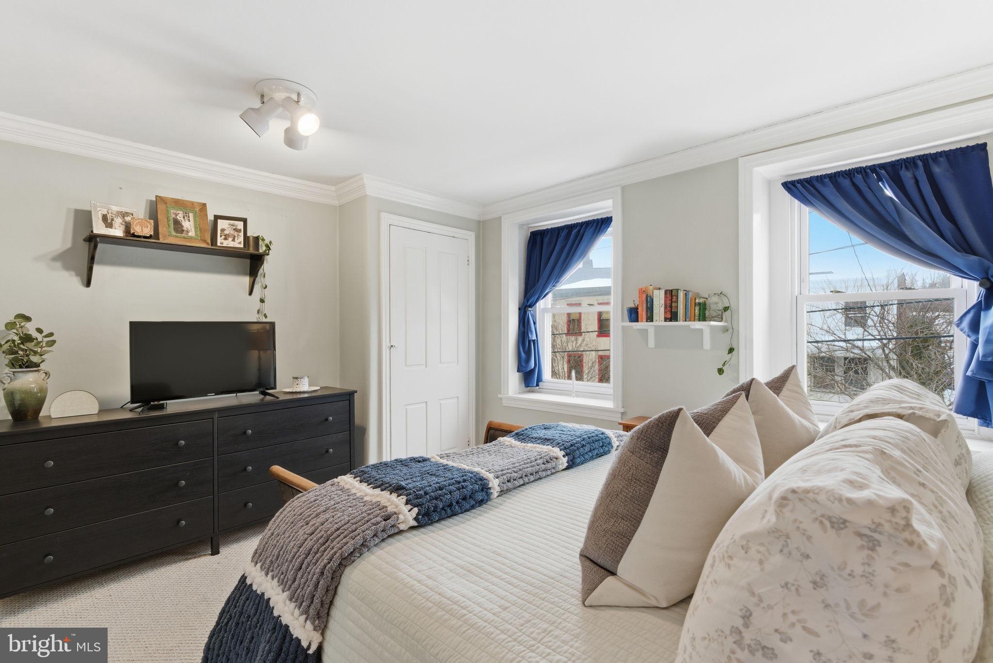 405 Leverington Avenue Philadelphia, PA 19128 - Photo 14 of 25 a bedroom with a bed and a flat screen tv