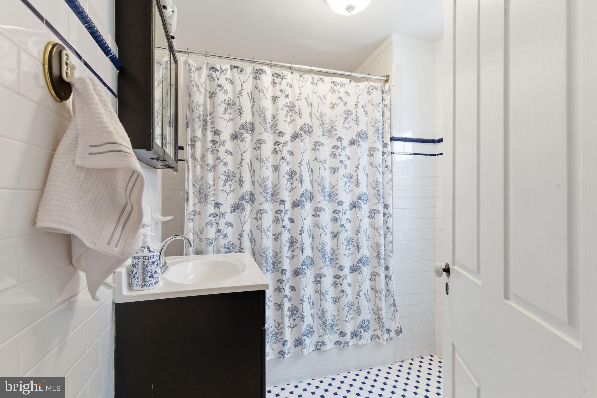 405 Leverington Avenue Philadelphia, PA 19128 - Photo 15 of 25 a bathroom with a sink and mirror