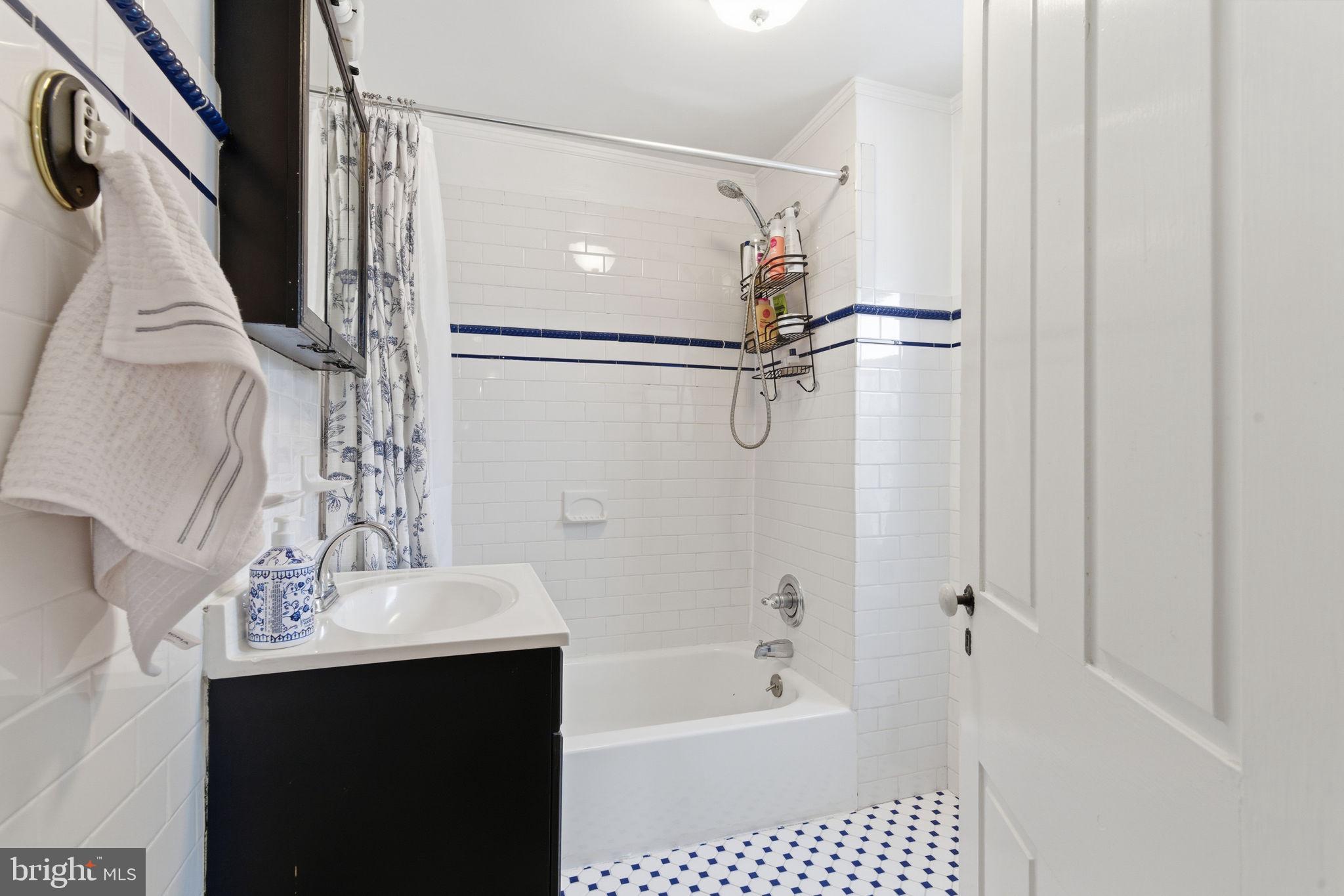 405 Leverington Avenue Philadelphia, PA 19128 - Photo 16 of 25 a bathroom with a bathtub a sink a vanity and a shower