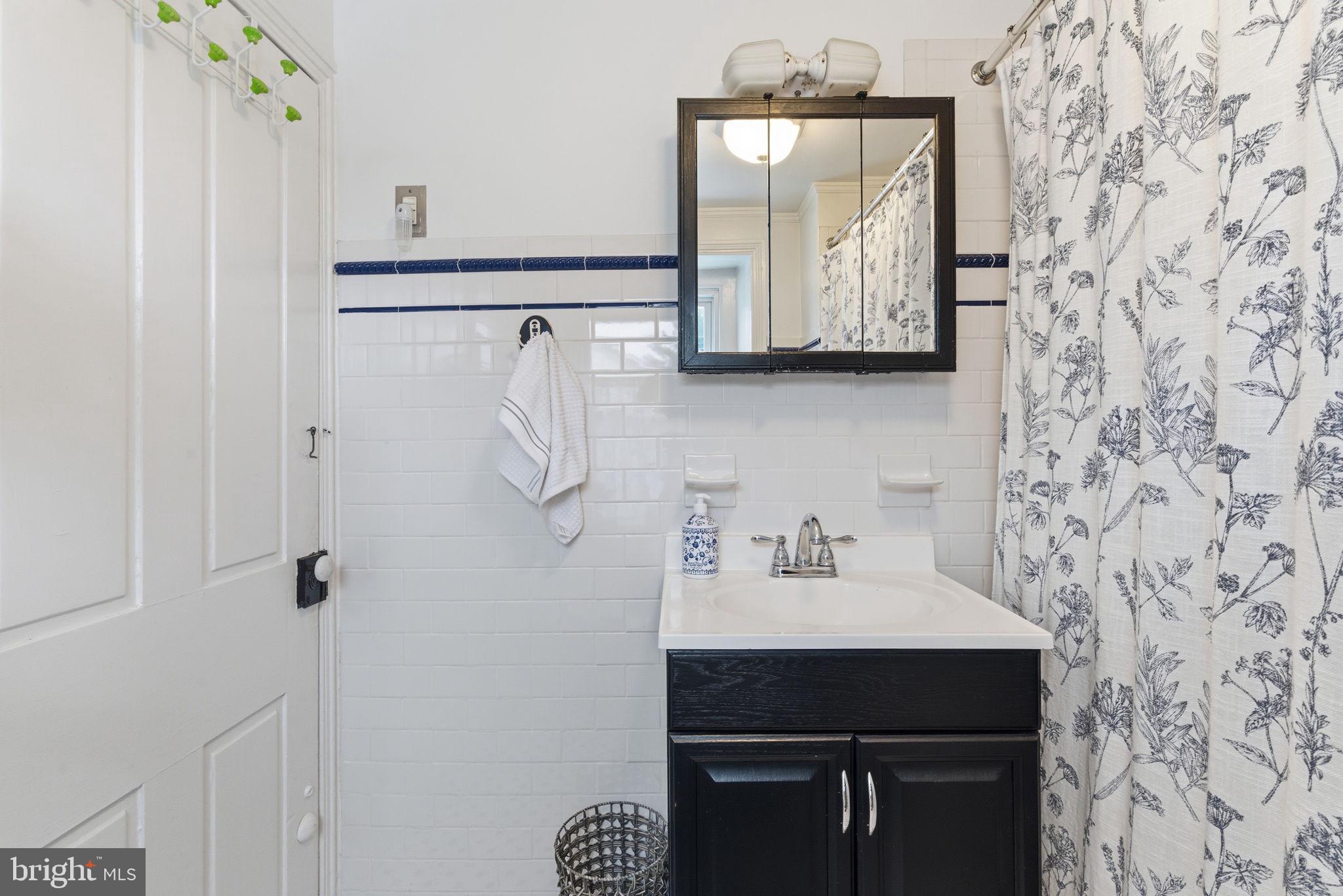405 Leverington Avenue Philadelphia, PA 19128 - Photo 17 of 25 a bathroom with a sink and mirror