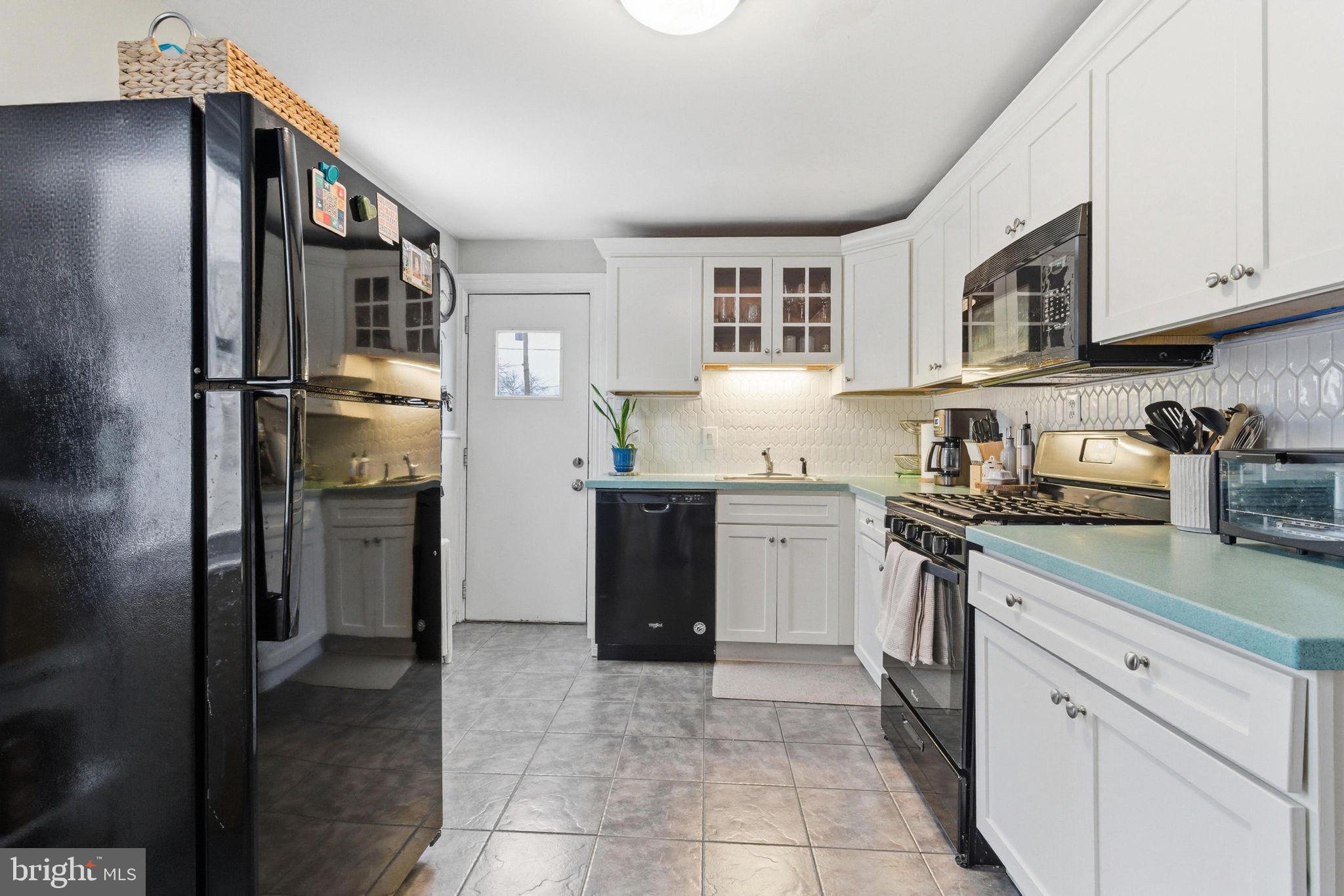 405 Leverington Avenue Philadelphia, PA 19128 - Photo 10 of 25 a kitchen with stainless steel appliances granite countertop a refrigerator and a sink