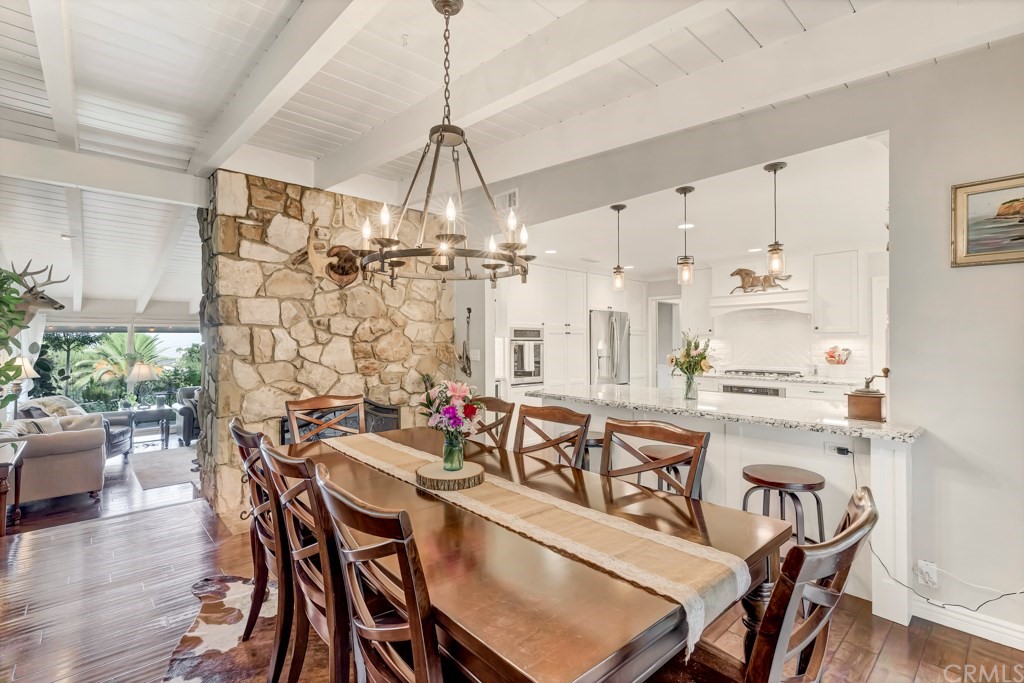 2601 Sunnyside Ridge Road Rancho Palos Verdes, CA 90275 - Photo 11 of 47 a view of a dining room and livingroom with furniture wooden floor a chandelier