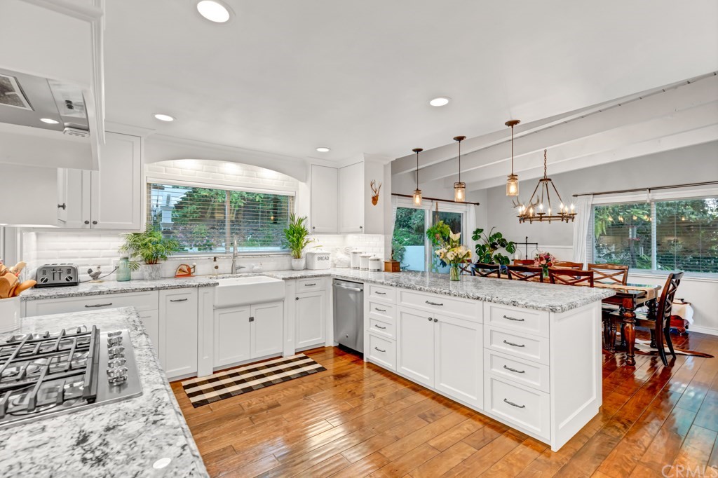 2601 Sunnyside Ridge Road Rancho Palos Verdes, CA 90275 - Photo 12 of 47 a kitchen with stainless steel appliances kitchen island granite countertop a table and chairs in it