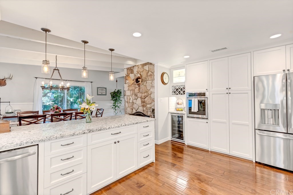 2601 Sunnyside Ridge Road Rancho Palos Verdes, CA 90275 - Photo 15 of 47 a kitchen with white cabinets and refrigerator