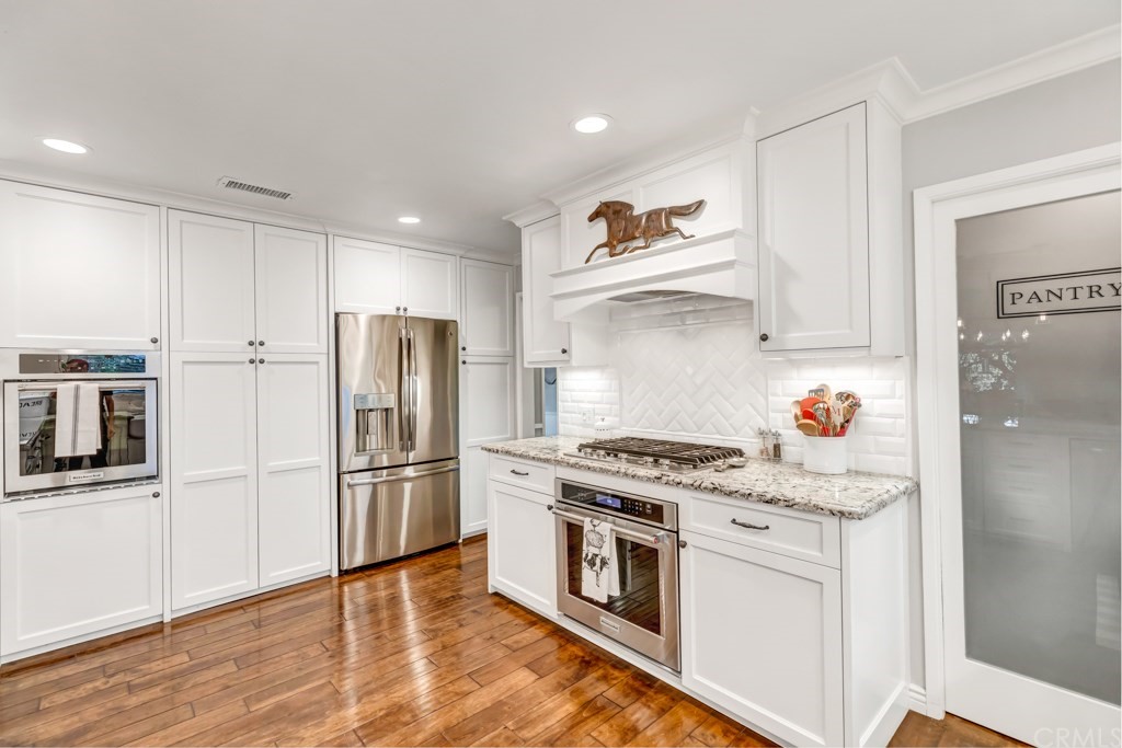 2601 Sunnyside Ridge Road Rancho Palos Verdes, CA 90275 - Photo 16 of 47 a kitchen with stainless steel appliances granite countertop a refrigerator stove and sink