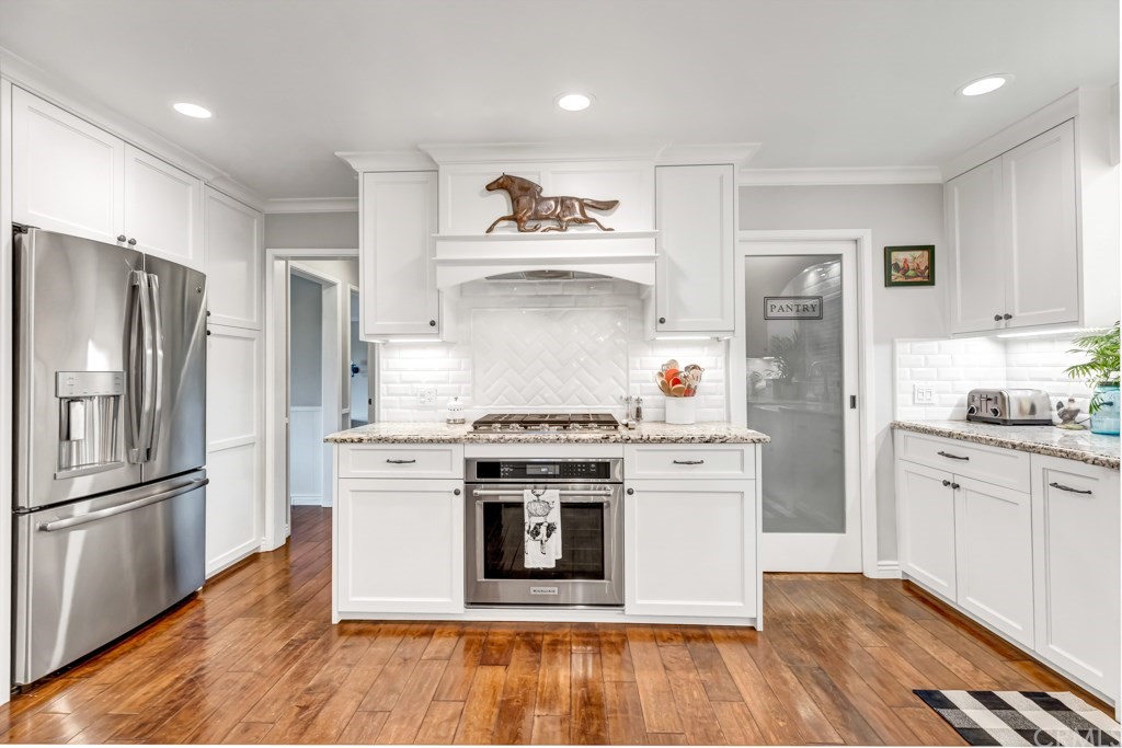 2601 Sunnyside Ridge Road Rancho Palos Verdes, CA 90275 - Photo 17 of 47 a kitchen with stainless steel appliances a stove and white cabinets