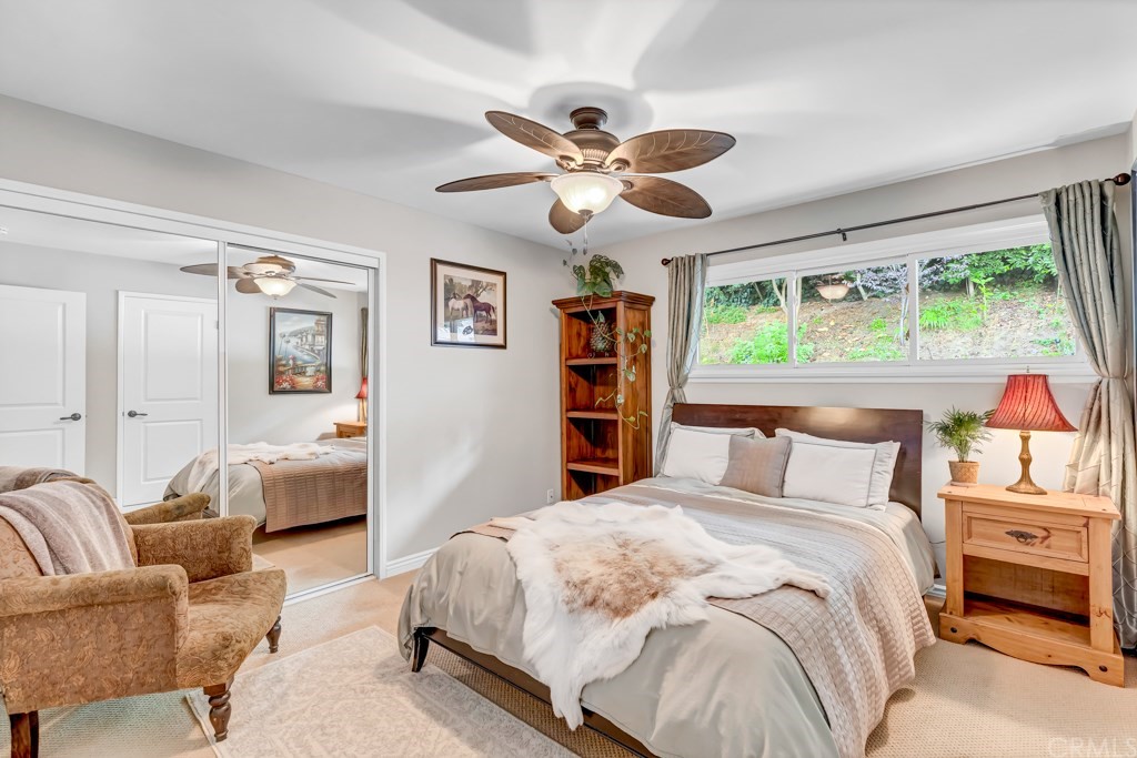 2601 Sunnyside Ridge Road Rancho Palos Verdes, CA 90275 - Photo 23 of 47 a bedroom with a large bed and a chandelier