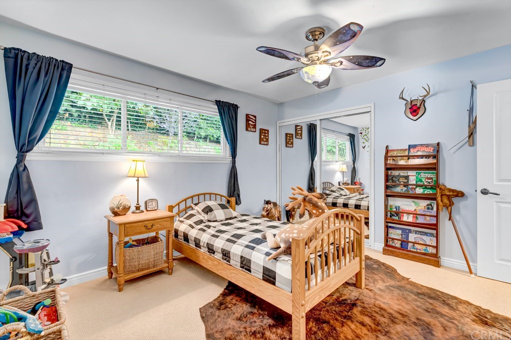 2601 Sunnyside Ridge Road Rancho Palos Verdes, CA 90275 - Photo 26 of 47 a bedroom with furniture a bed and a chandelier