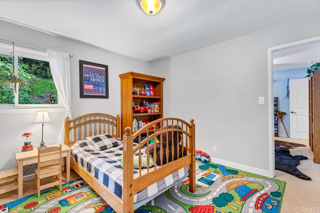 2601 Sunnyside Ridge Road Rancho Palos Verdes, CA 90275 - Photo 28 of 47 a bedroom with furniture and a baby crib
