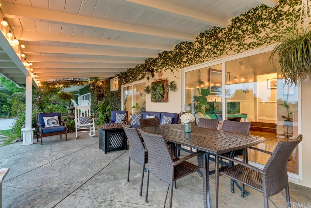 2601 Sunnyside Ridge Road Rancho Palos Verdes, CA 90275 - Photo 3 of 47 a view of a patio with a dining table and chairs with wooden floor