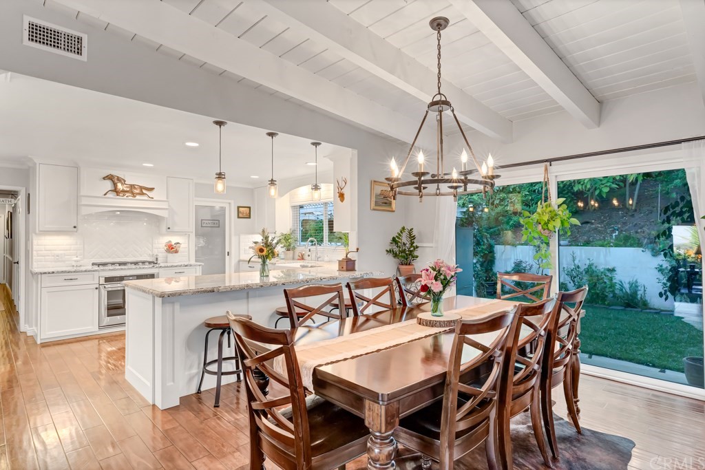 2601 Sunnyside Ridge Road Rancho Palos Verdes, CA 90275 - Photo 10 of 47 a dining room with furniture a chandelier and wooden floor