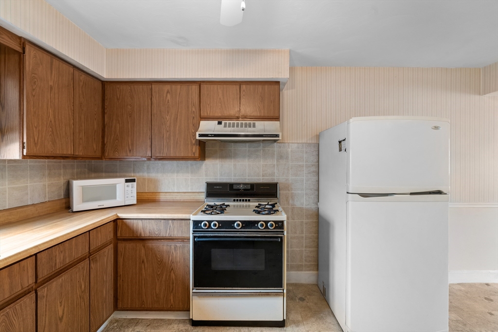 70 North Court Street, Unit F Fall River, MA 02720 - Photo 8 of 20 a kitchen with a stove and a refrigerator