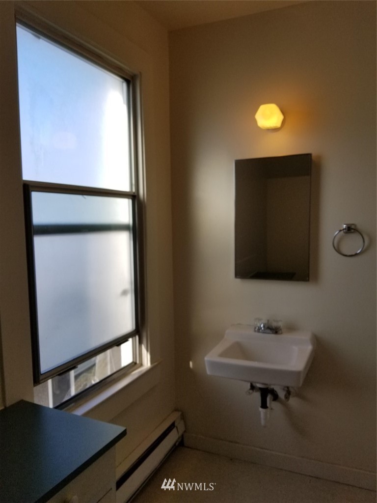 3430 Rucker Avenue Everett, WA 98201 - Photo 11 of 11 a bathroom with a toilet sink and mirror