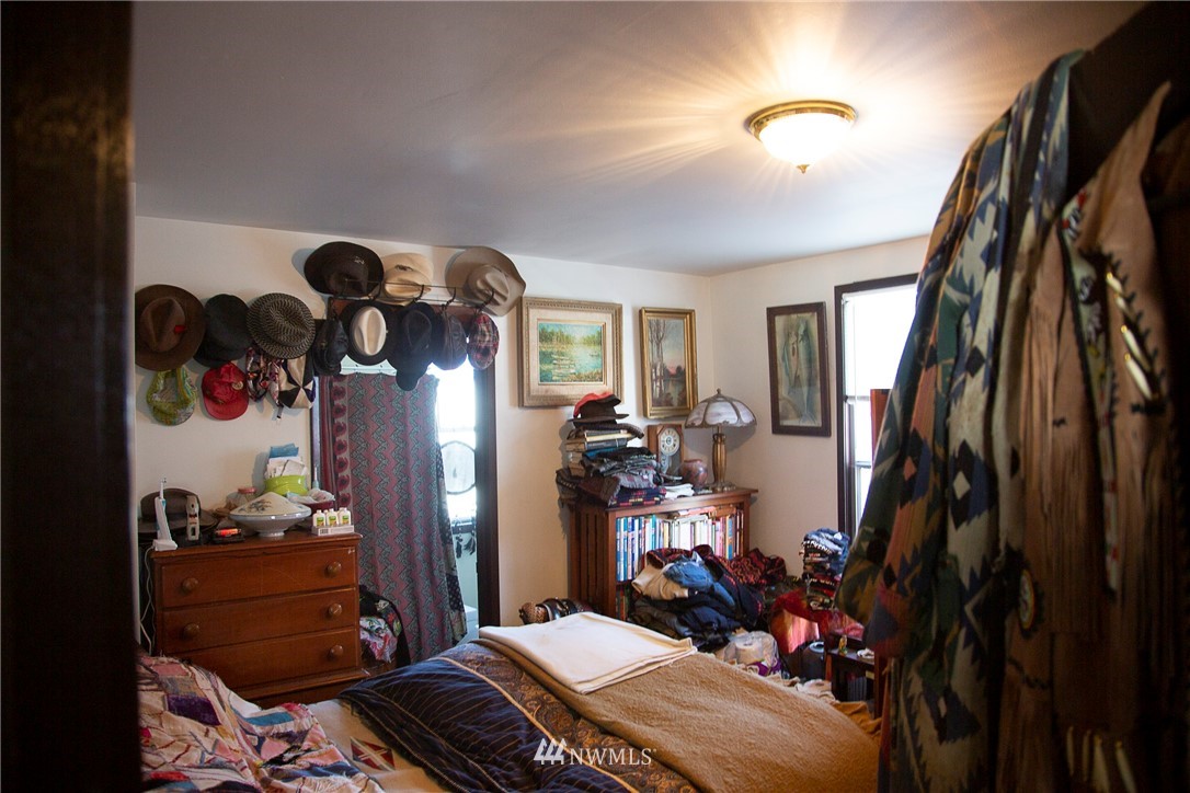 3430 Rucker Avenue Everett, WA 98201 - Photo 4 of 11 a bedroom with a bed closet and a mirror