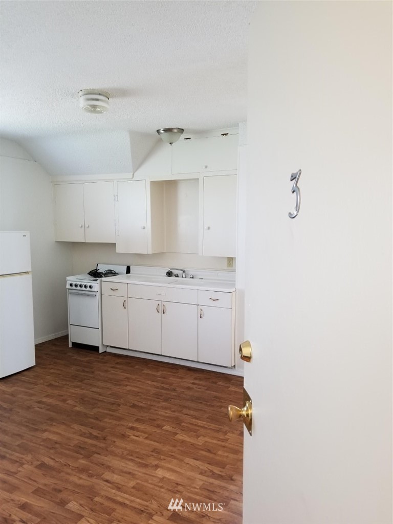 3430 Rucker Avenue Everett, WA 98201 - Photo 6 of 11 a kitchen with cabinets window and a sink