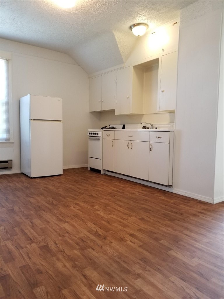 3430 Rucker Avenue Everett, WA 98201 - Photo 7 of 11 a view of a kitchen with wooden floor and electronic appliances