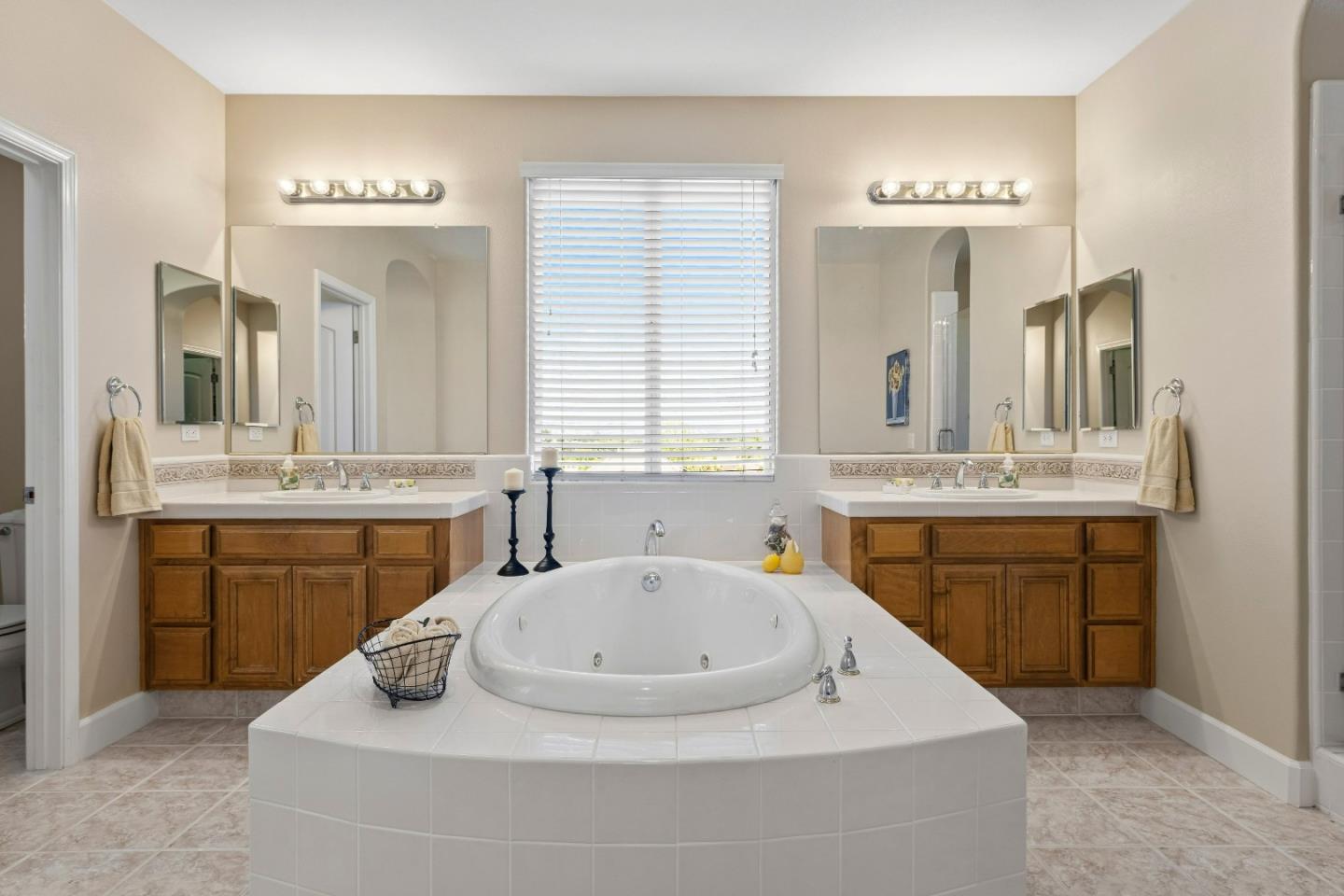 7466 Dunbar Court Gilroy, CA 95020 - Photo 60 of 103 a bathroom with a sink double vanity granite tub shower and a mirror