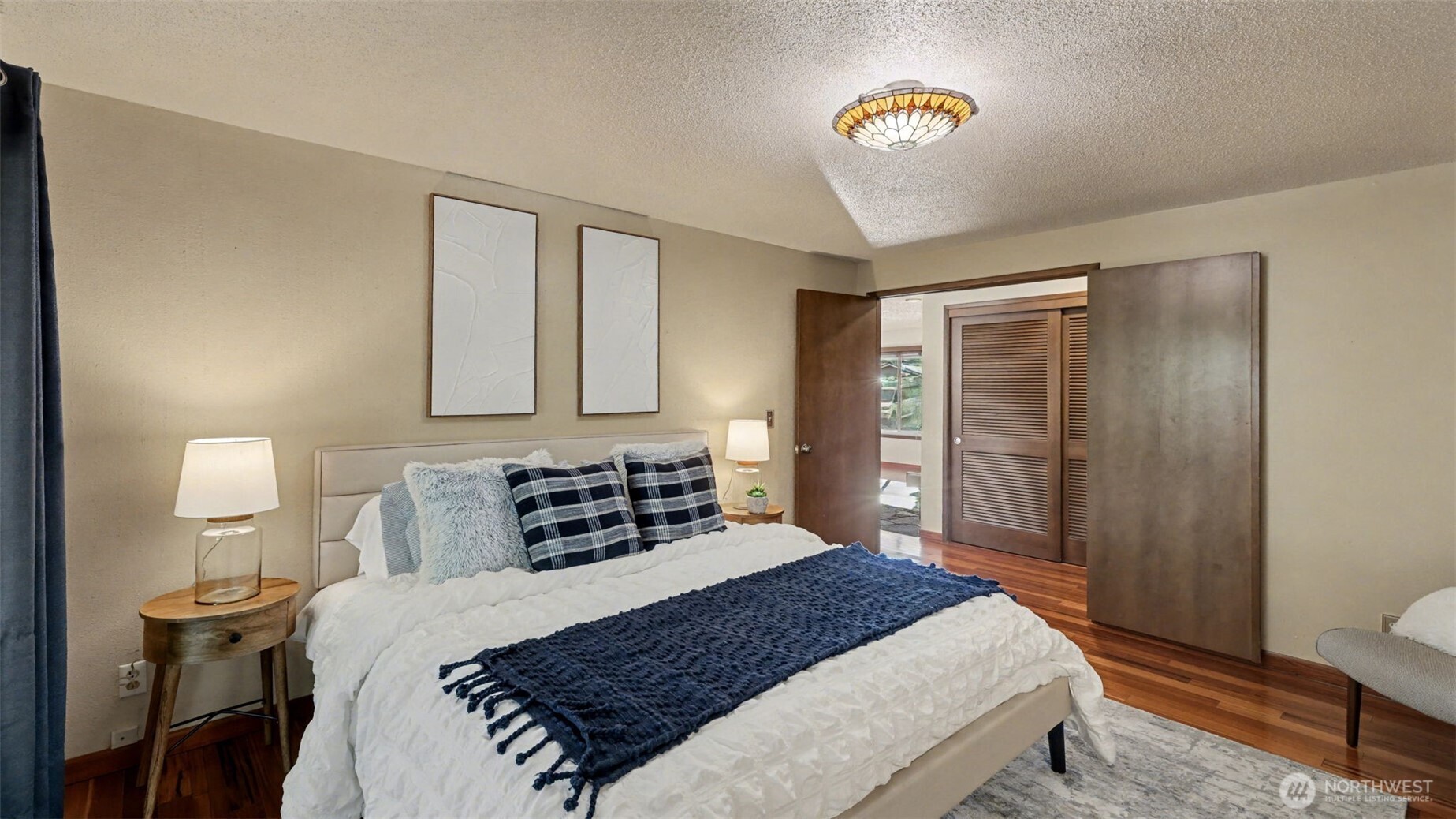 14604 Southeast 167th Place Renton, WA 98058 - Photo 17 of 23 a bedroom with a bed and a lamp