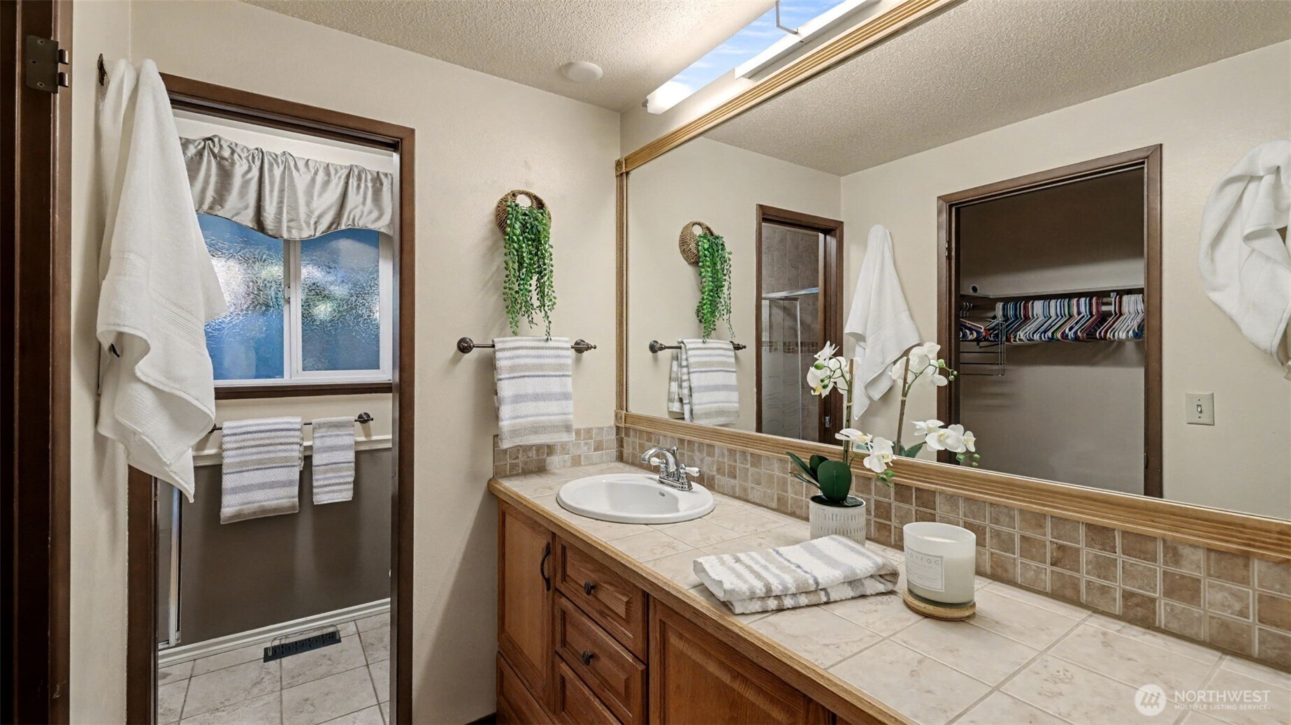 14604 Southeast 167th Place Renton, WA 98058 - Photo 18 of 23 a bathroom with a granite countertop sink and a mirror