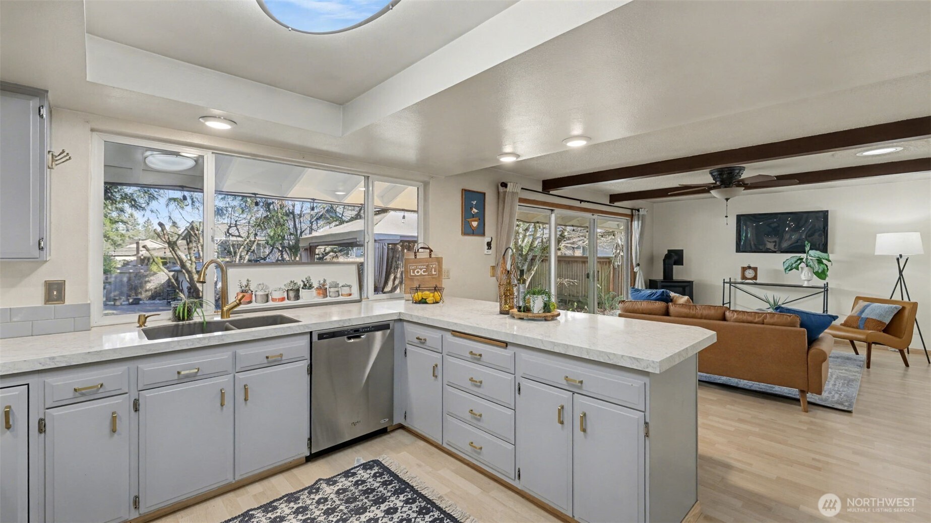 14604 Southeast 167th Place Renton, WA 98058 - Photo 7 of 23 a kitchen with sink cabinets and living room