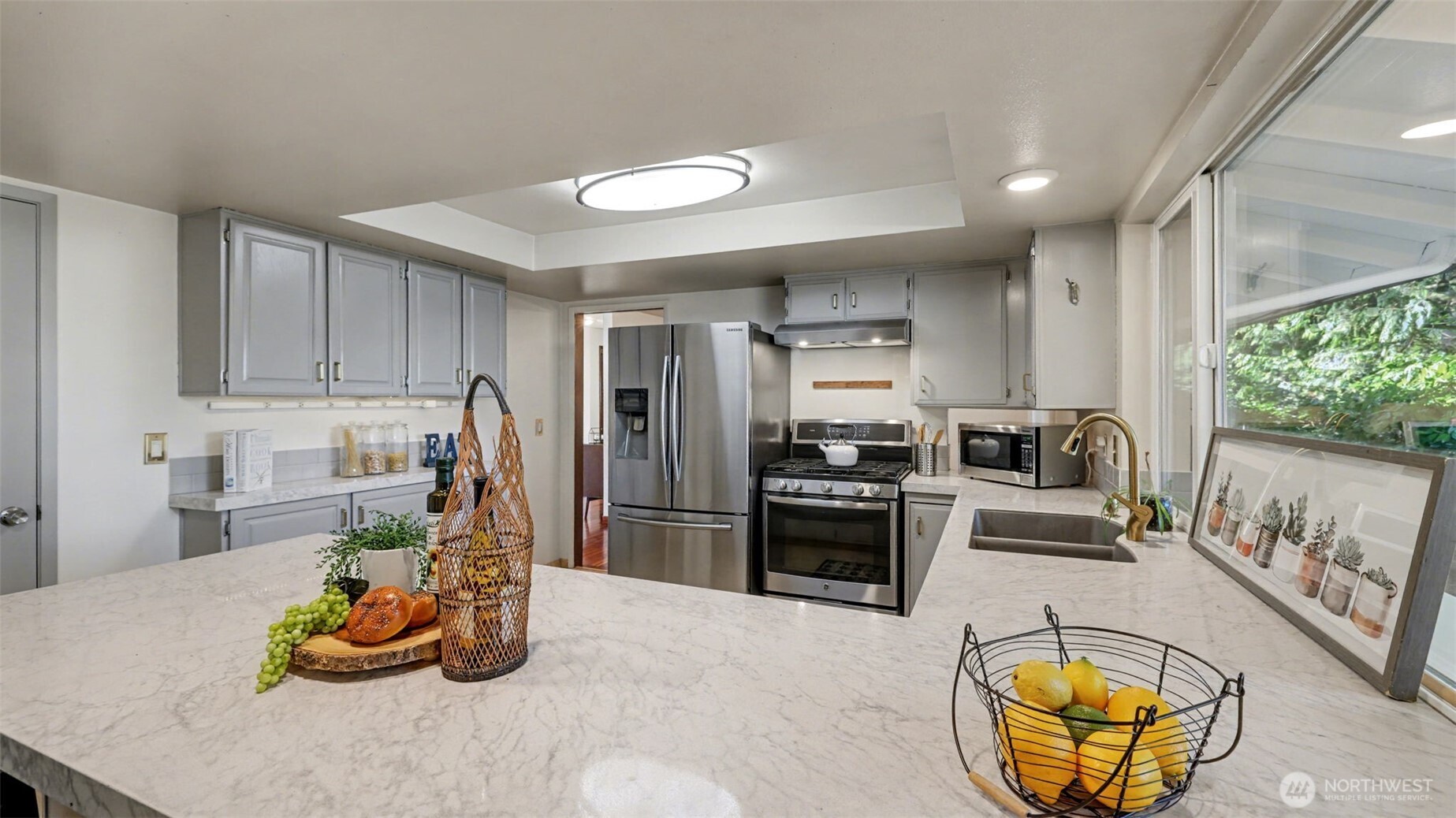 14604 Southeast 167th Place Renton, WA 98058 - Photo 10 of 23 a kitchen with stainless steel appliances granite countertop a sink refrigerator and microwave