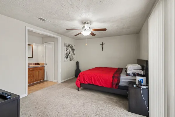 a bedroom with a bed and a chandelier