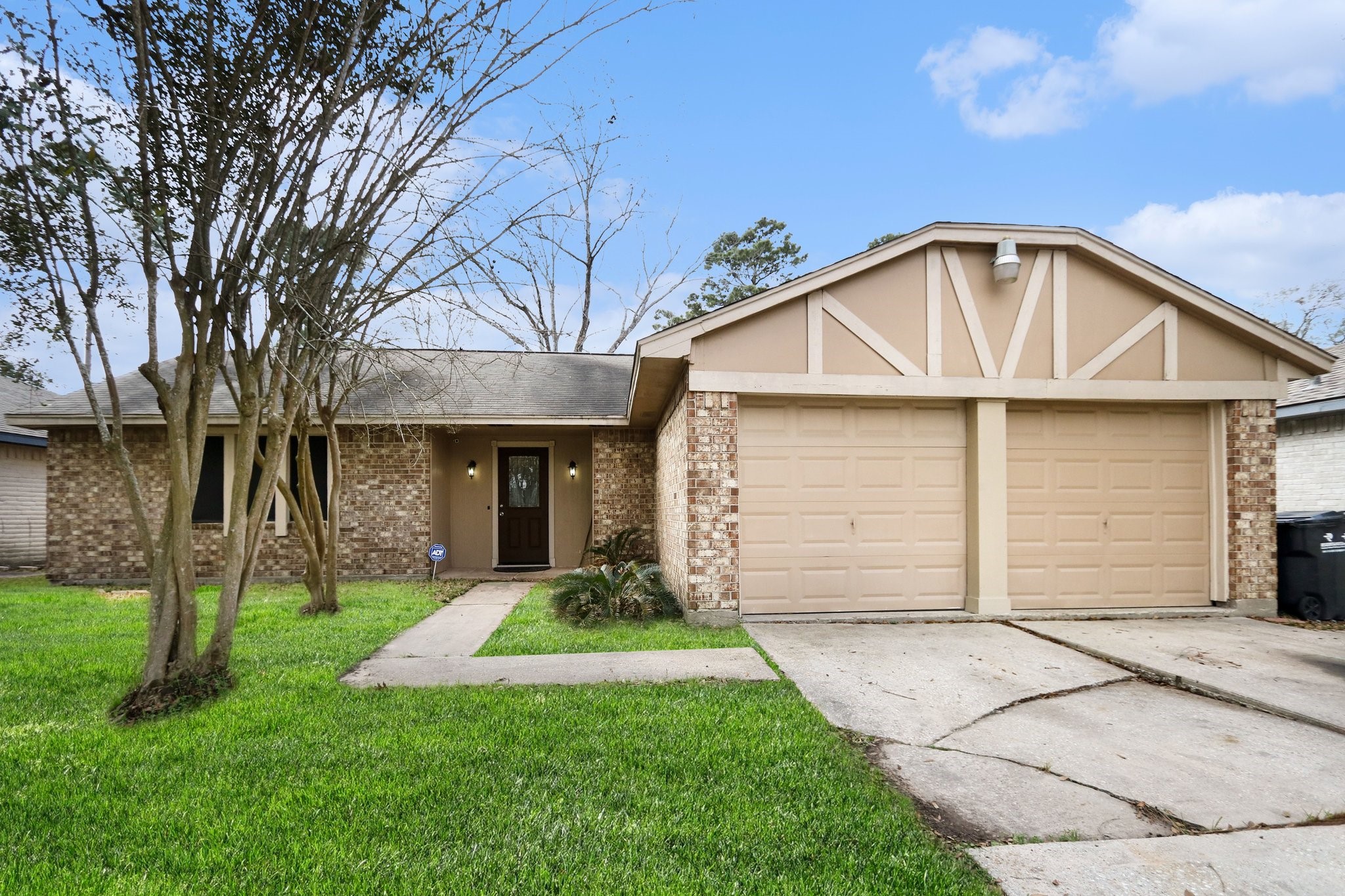23219 Good Dale Lane Spring, TX 77373 - Photo 2 of 20 a view of a white house with a small yard and large trees