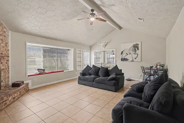 a living room with furniture and a large window