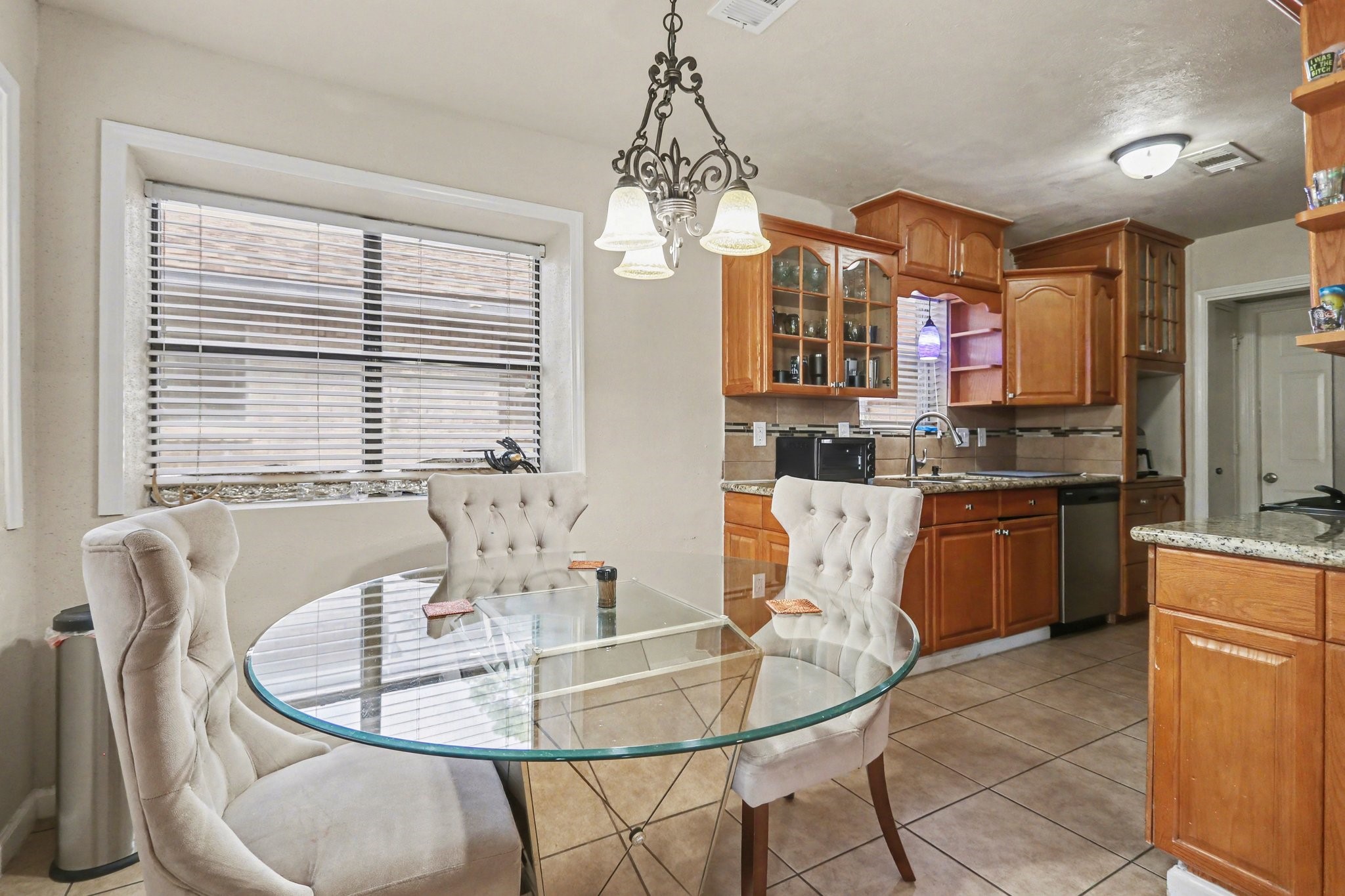 23219 Good Dale Lane Spring, TX 77373 - Photo 7 of 20 a kitchen with stainless steel appliances granite countertop a dining table chairs and a chandelier