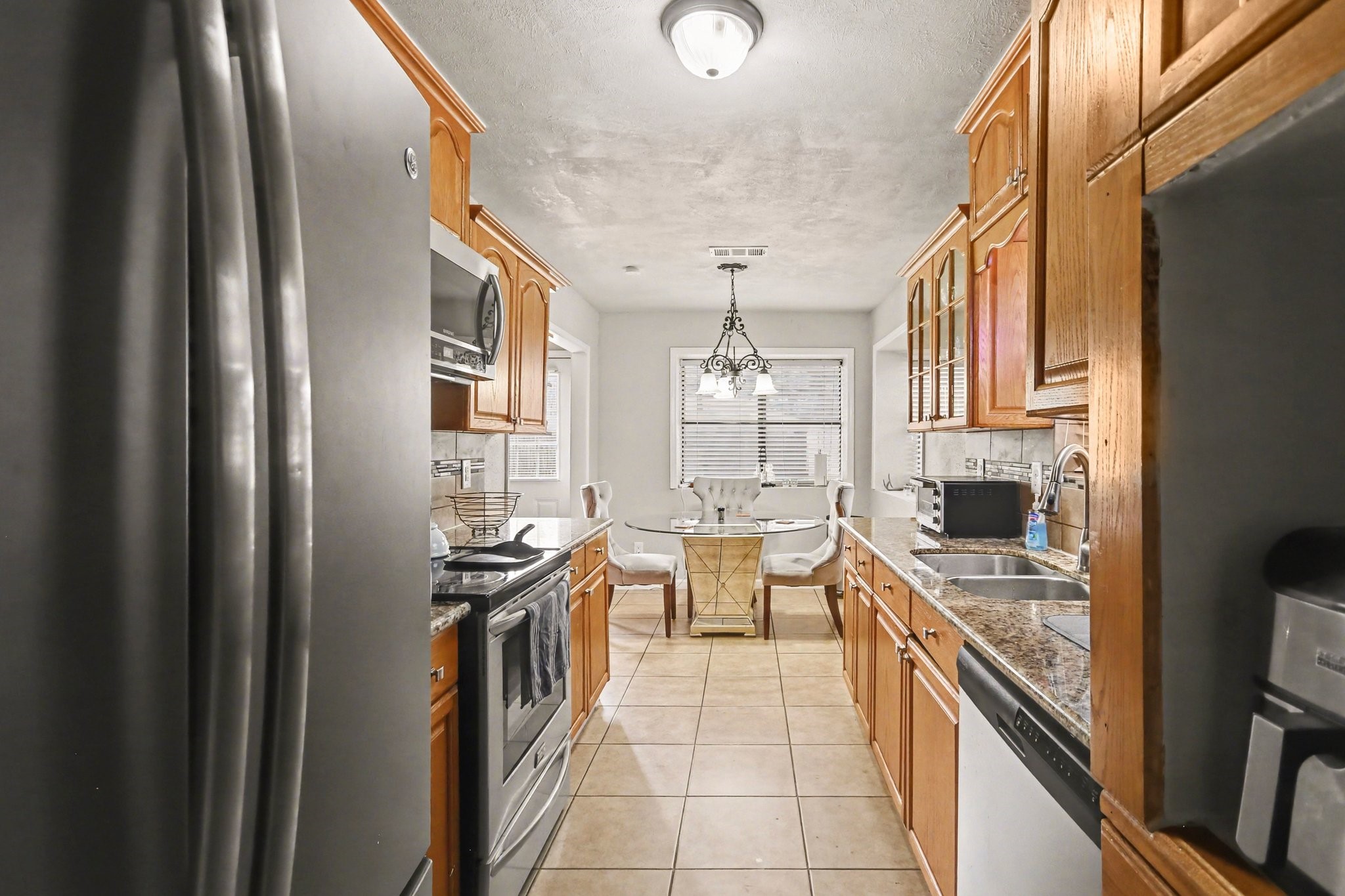 23219 Good Dale Lane Spring, TX 77373 - Photo 8 of 20 a kitchen with stainless steel appliances granite countertop a sink stove and refrigerator