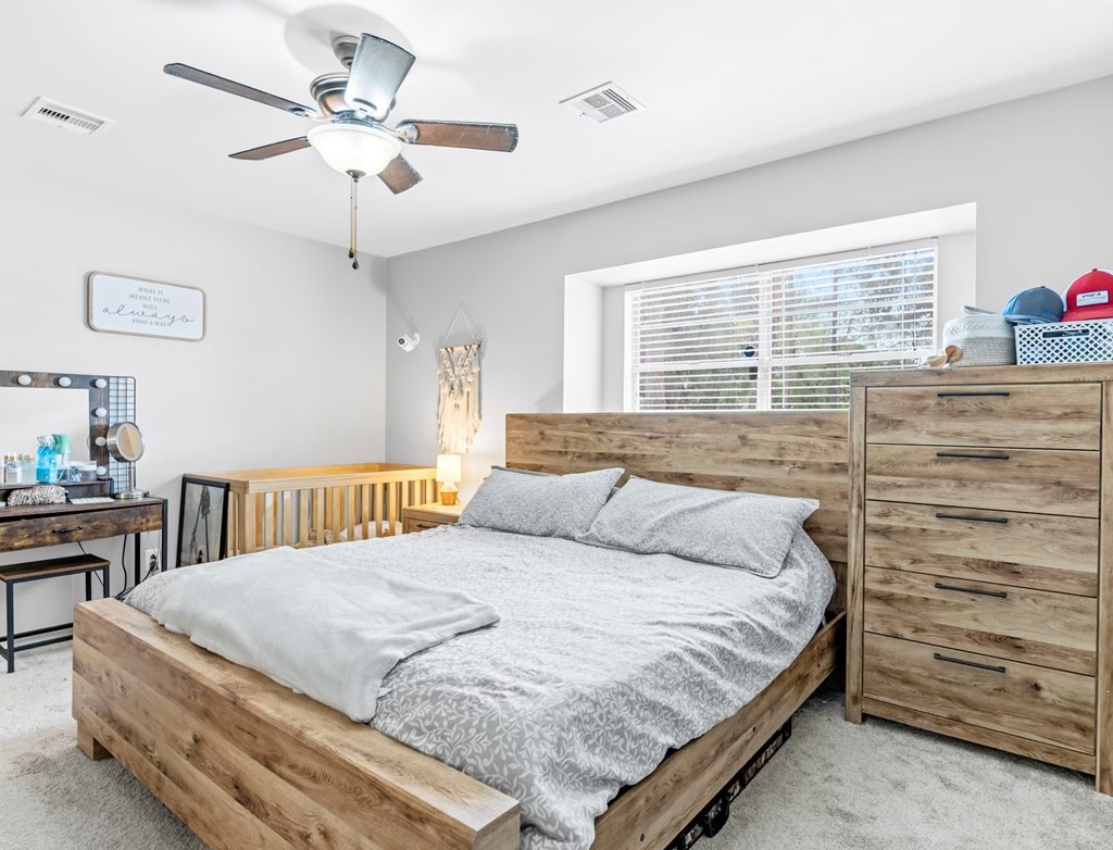 4009 Rice Avenue Bay City, TX 77414 - Photo 11 of 26 a bedroom with a bed chandelier and a window