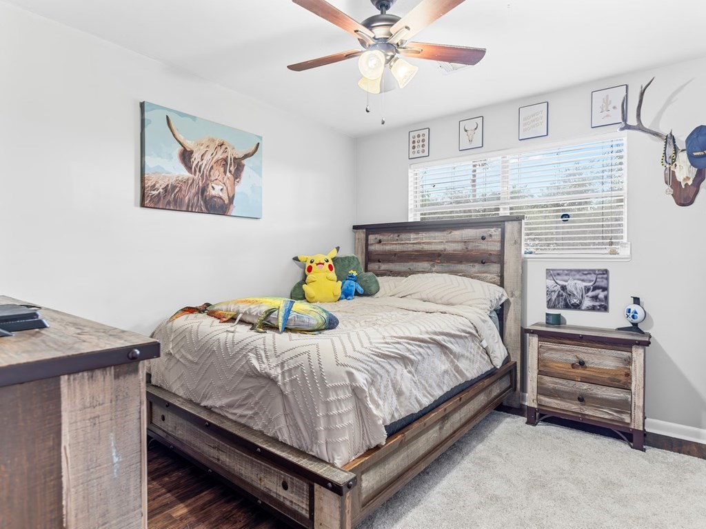 4009 Rice Avenue Bay City, TX 77414 - Photo 19 of 26 a bedroom with a bed and a chandelier