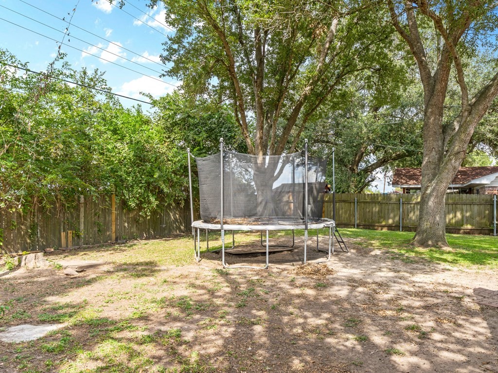 4009 Rice Avenue Bay City, TX 77414 - Photo 24 of 26 a backyard of a house with table and chairs