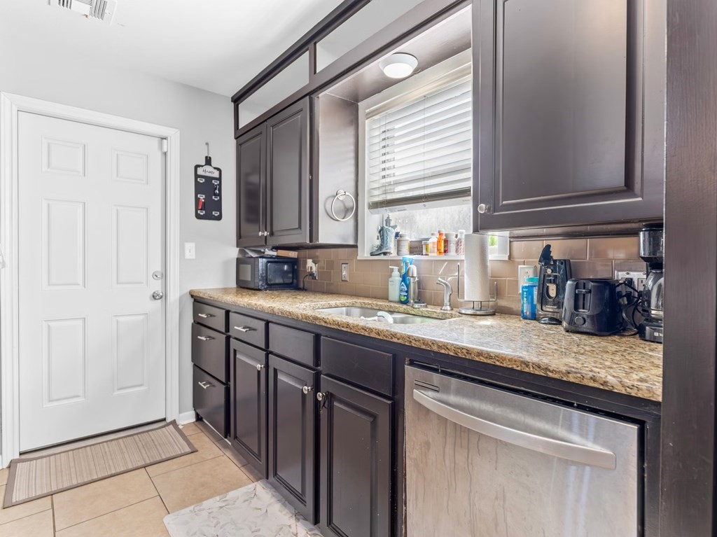 4009 Rice Avenue Bay City, TX 77414 - Photo 3 of 26 a kitchen with stainless steel appliances granite countertop a sink and a cabinets
