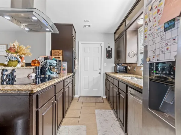 a kitchen with stainless steel appliances granite countertop a sink and stove top oven