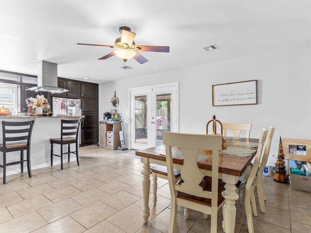 4009 Rice Avenue Bay City, TX 77414 - Photo 7 of 26 a view of a dining room with furniture and chandelier