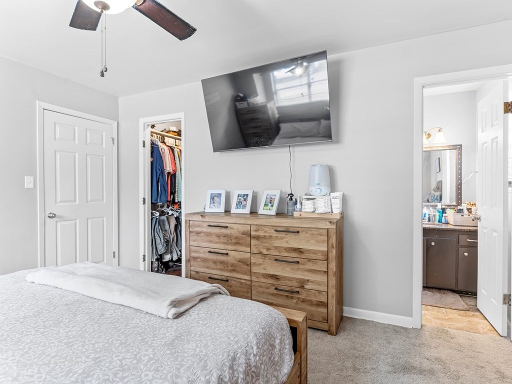 4009 Rice Avenue Bay City, TX 77414 - Photo 9 of 26 a bedroom with a bed and a flat tv screen