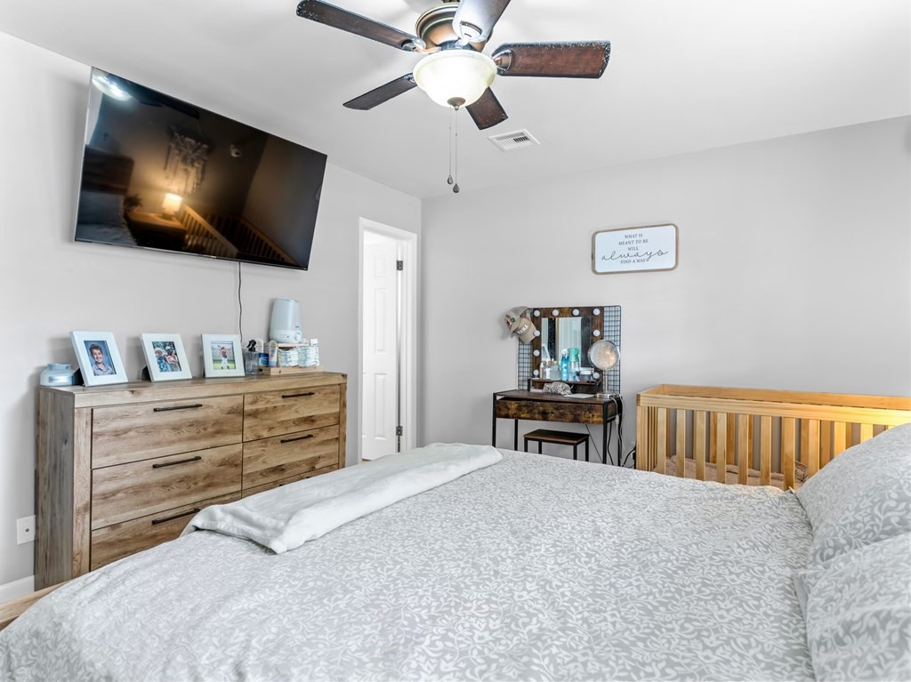 4009 Rice Avenue Bay City, TX 77414 - Photo 10 of 26 a bedroom with a bed and a flat screen tv